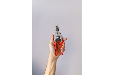 electrical pliers in the hands of a, an Industrial Photo by yanadjana