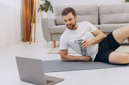 Handsome adult man using laptop and drinking water while having, a Sports & Recreation Photo by Cherkas Photography
