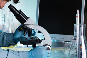 Researcher looking at a sample under, a Health & Medical Photo by angellodeco