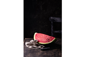 Sliced watermelon on black wooden, a Food & Drink Photo by Yulia Furman