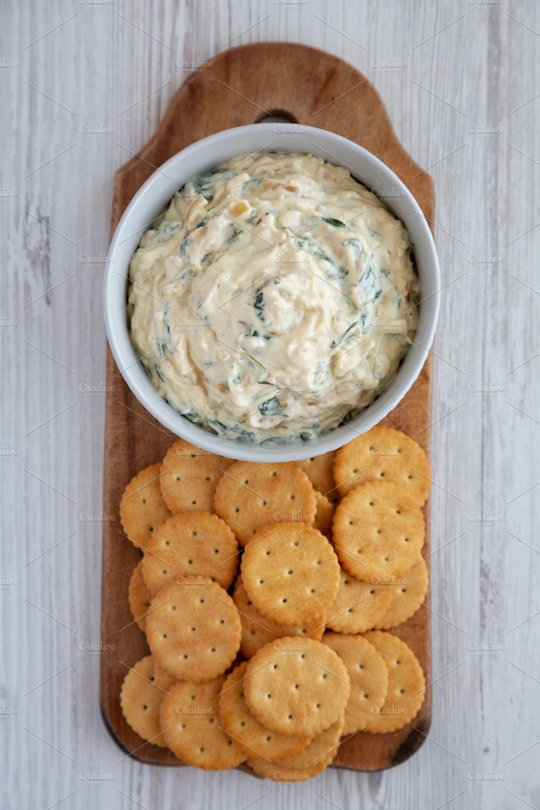 Homemade Caramelized Onion and Spinach Dip with Salty Round Crac, a Food & Drink Photo by LiudmylaChuhunova
