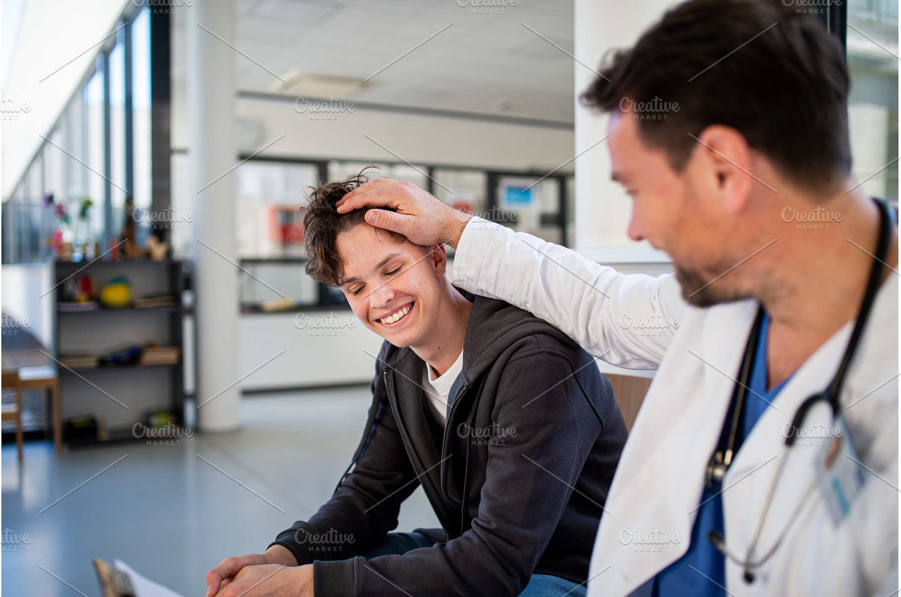 Teenage boy smiling talking with, a Sports & Recreation Photo by HalfPoint