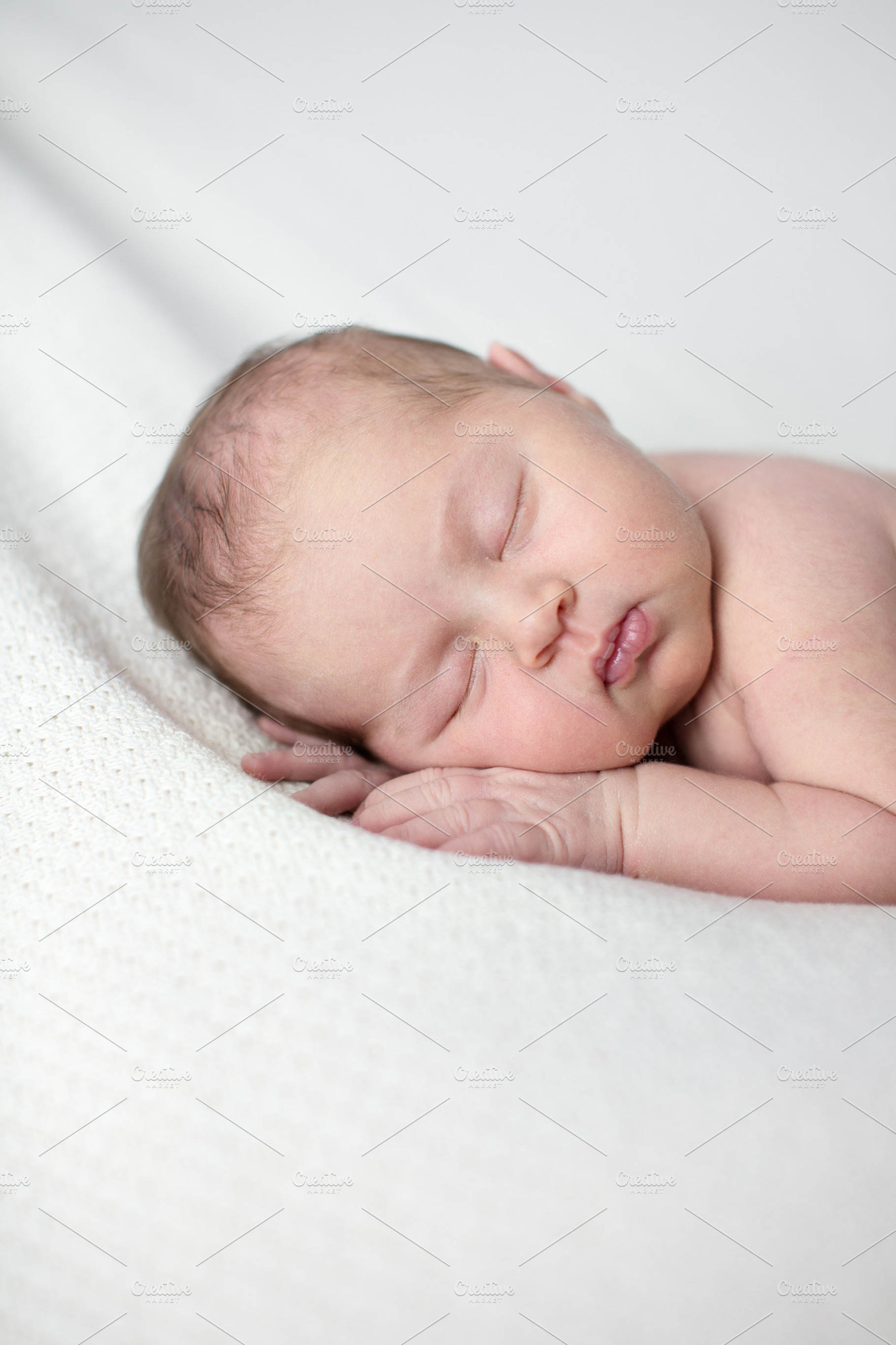 Newborn sleeping white closeup stock photo containing innocence and happy, a Person Photo by Natalia Lebedinskaia