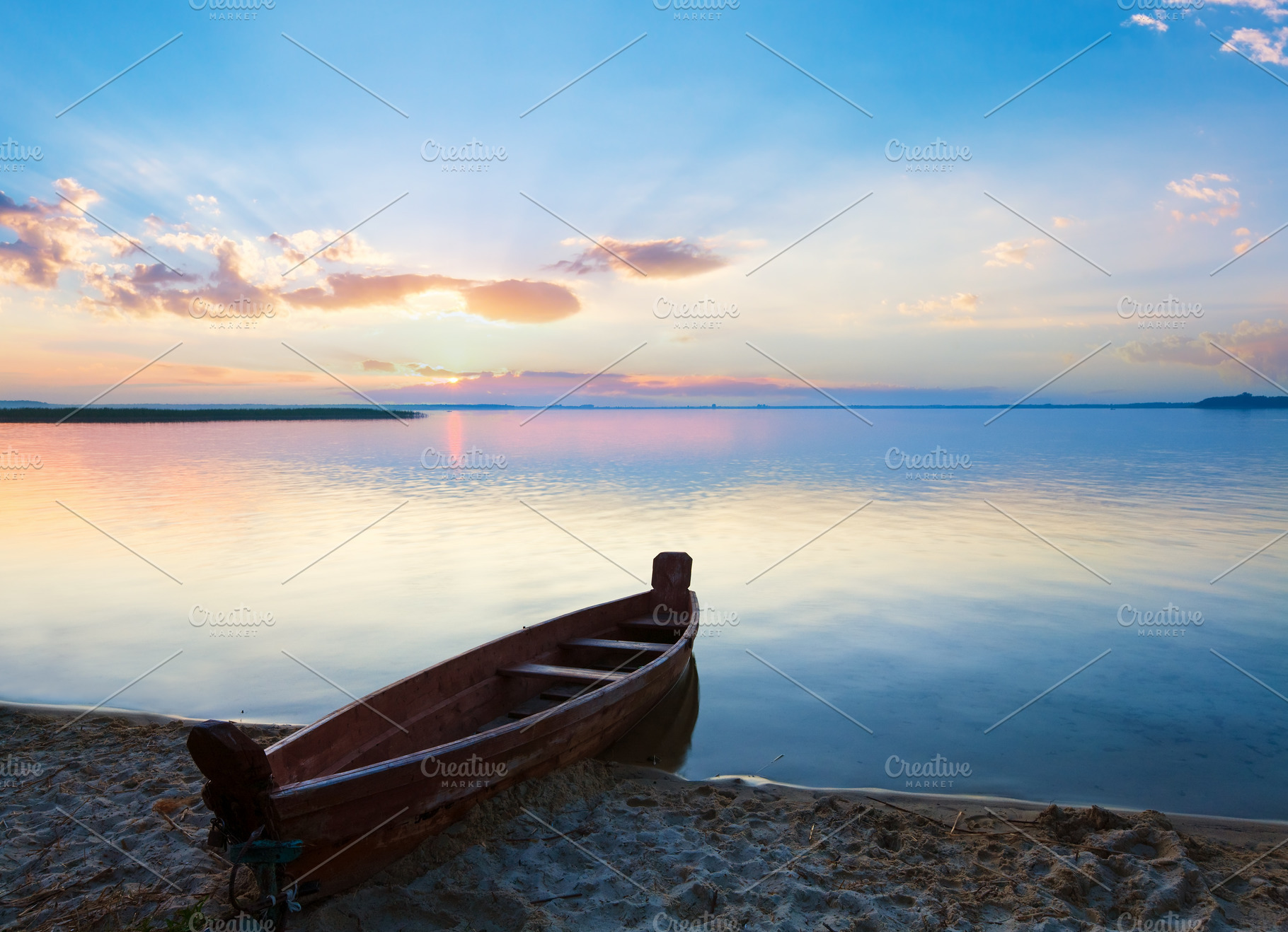 Sunset with boat near the summer lake shore, a Nature Photo by YuriyB