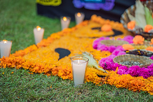 Glowing candle in a glass beside a