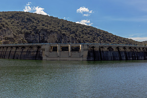 Concrete Dam Over a Reservoir with a, an Industrial Photo by Perpis