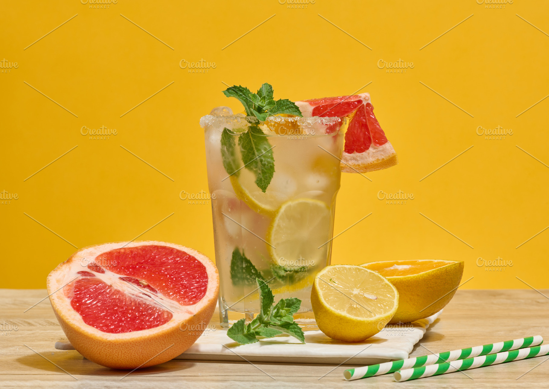 Glass with a cold drink, grapefruit slices, ice, mint and lemon, a Food & Drink Photo by ndanko