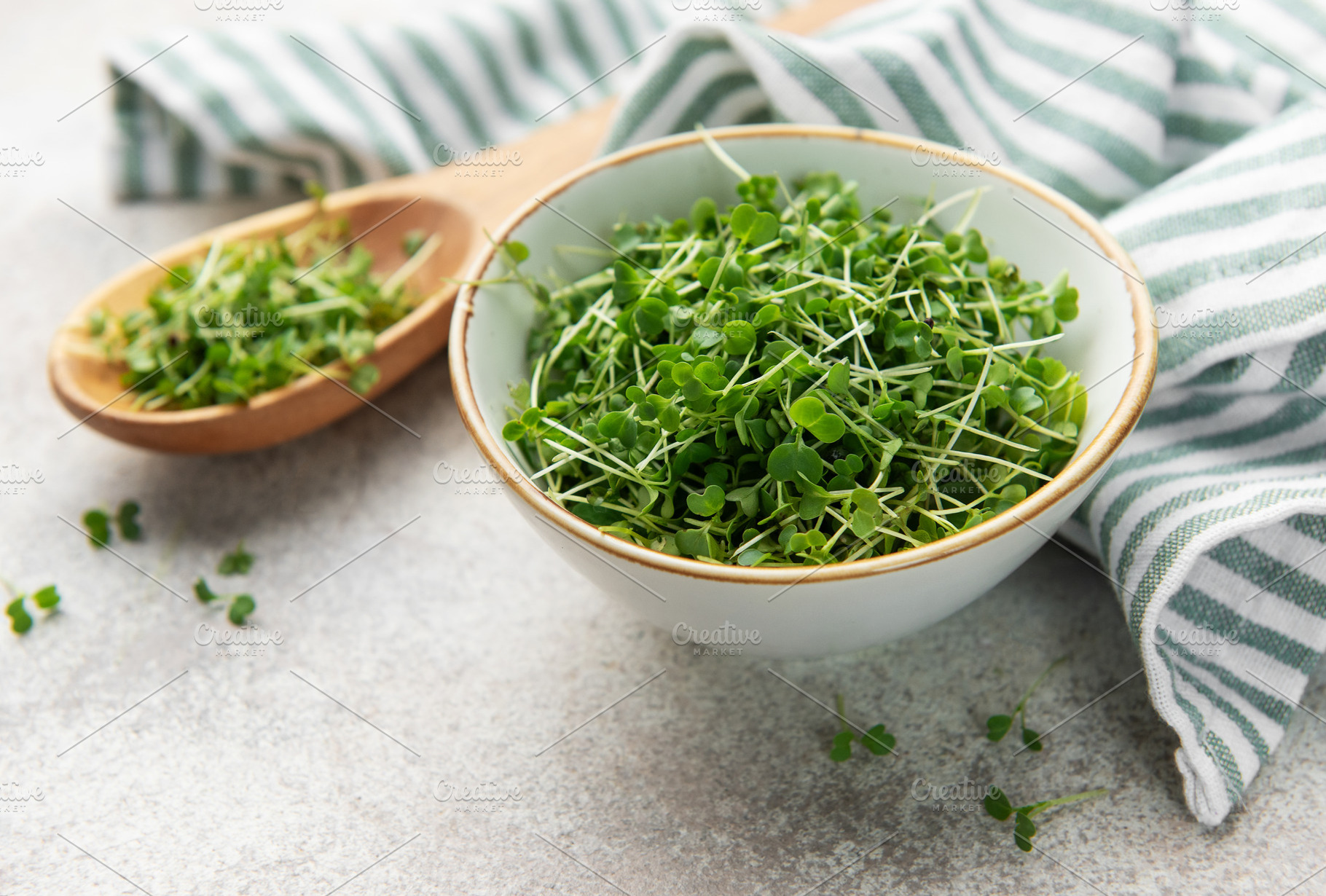 Fresh microgreens in bowl and wooden spoon, a Food & Drink Photo by Olena Rudo