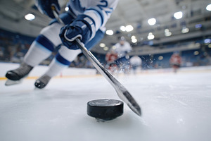 Dynamic hockey player in action on ice, a Sports & Recreation Photo by AlyaAnd