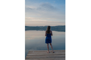 Woman in Blue Towel Sitting on Dock, a Person Photo by Jan Jack Russo Media
