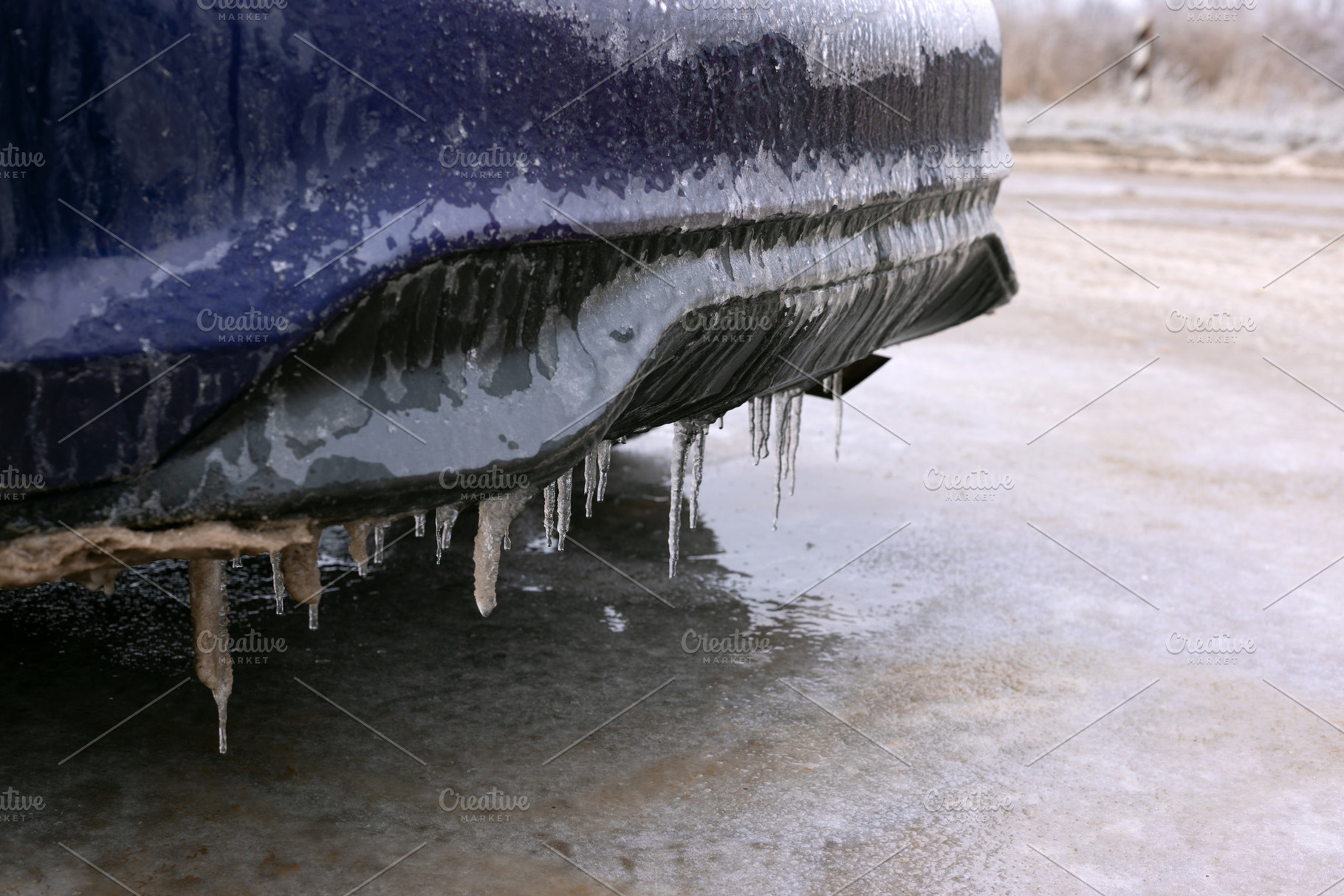 Close-up of car bumper with icicles hanging in winter conditions, a Transportation Photo by Ales Munt