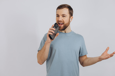 Happy bearded man dancing with earphones, listening music in hea, a Technology Photo by Cherkas Photography