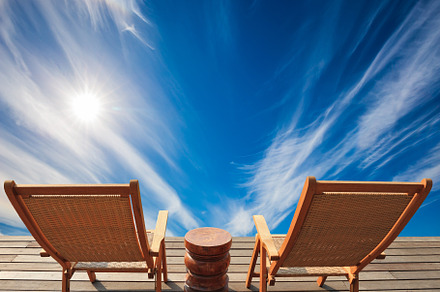 Two deck chairs on a wooden platform