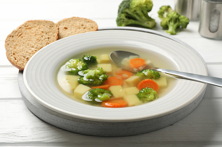 Soup on wooden background, close up. Healthy food, a Food & Drink Photo by AtlasStudio