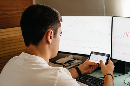 Successful young trader in casual wear working with charts and market reports a, a Person Photo by Architect´s eye