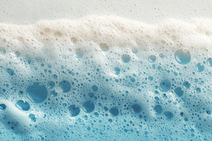 Bubbles and foam mix in blue water, a Photo by Pavel_design