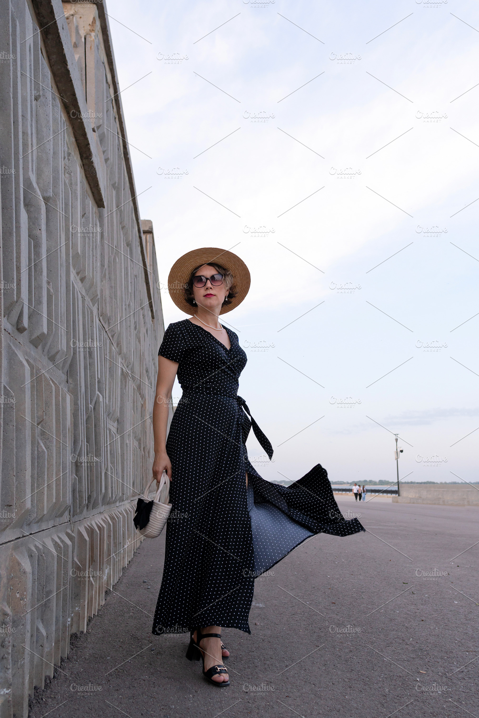 Confident woman in black dress stand, a Person Photo by Elena Vagengeim