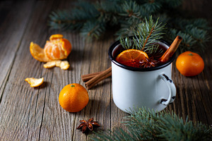 Traditional tasty mulled wine hot drink with mandarin apple spices and christma, a Food & Drink Photo by dashtik
