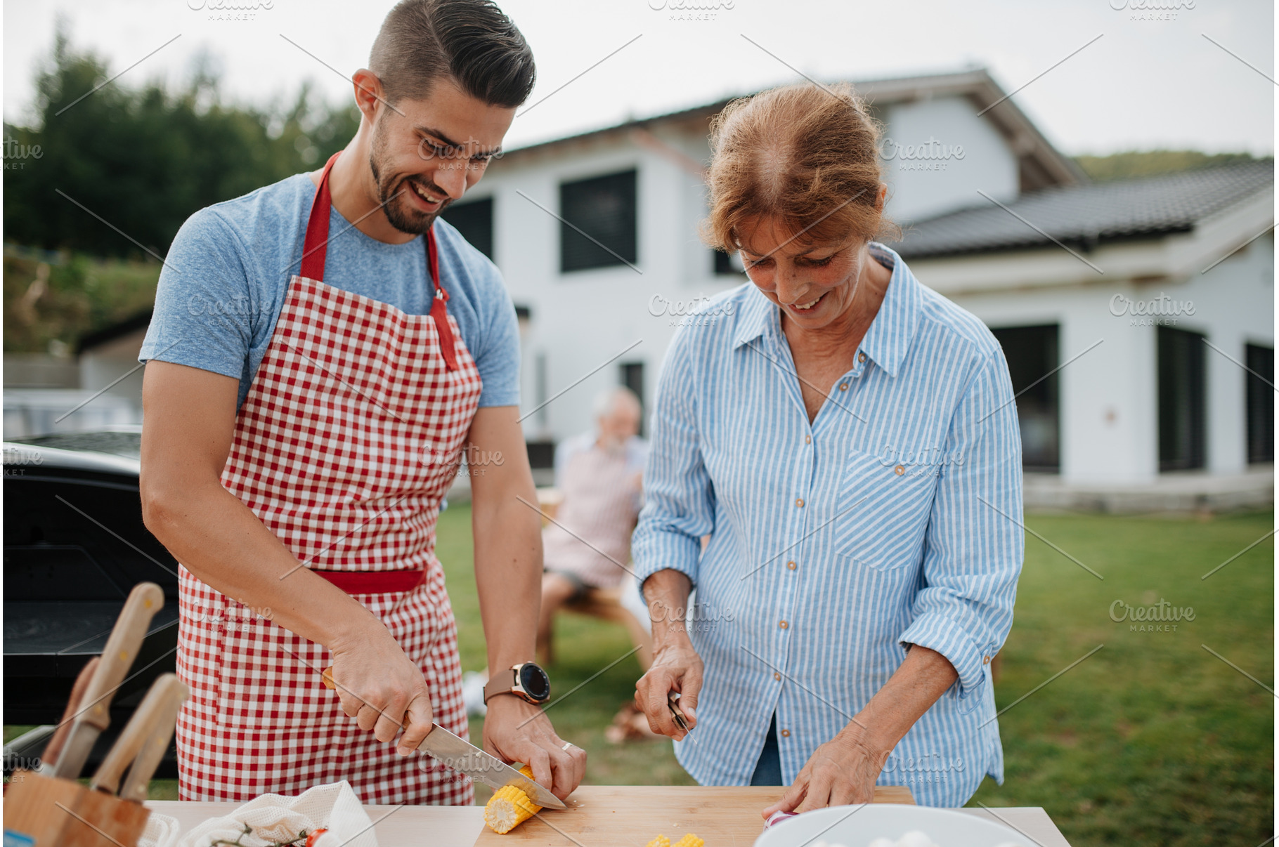Adult son and mother preparing food, a Person Photo by HalfPoint