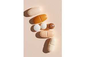 Assorted pills on neutral background, a Health & Medical Photo by Lermont51