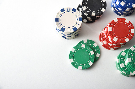 Stacks of colorful casino chips on white isolated table, an Arts & Entertainment Photo by Davizro's Market