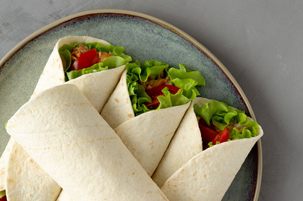 Homemade Avocado Tuna Wraps on a Plate, top view. Flat lay, over, a Food & Drink Photo by LiudmylaChuhunova