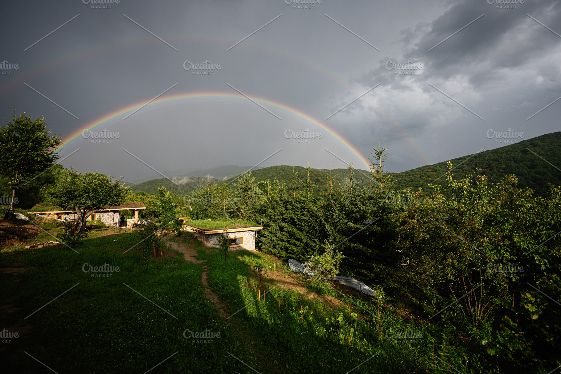 A scenic rural landscape with a vibrant double rainbow over rolling green hills, a Photo by AS photostudio