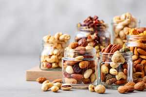 Assorted nuts in glass containers, a Food & Drink Photo by AlyaAnd