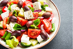 Greek salad in craft plate on black, a Food & Drink Photo by Nadia-nb
