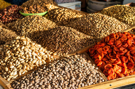 Oriental dried fruits and nuts on the counter of the bazaar., a Food & Drink Photo by Eugene_Photo