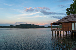 Sunset view of stilt house on Bolilanga Island, Togian archipela, an Architecture Photo by GoodGoods