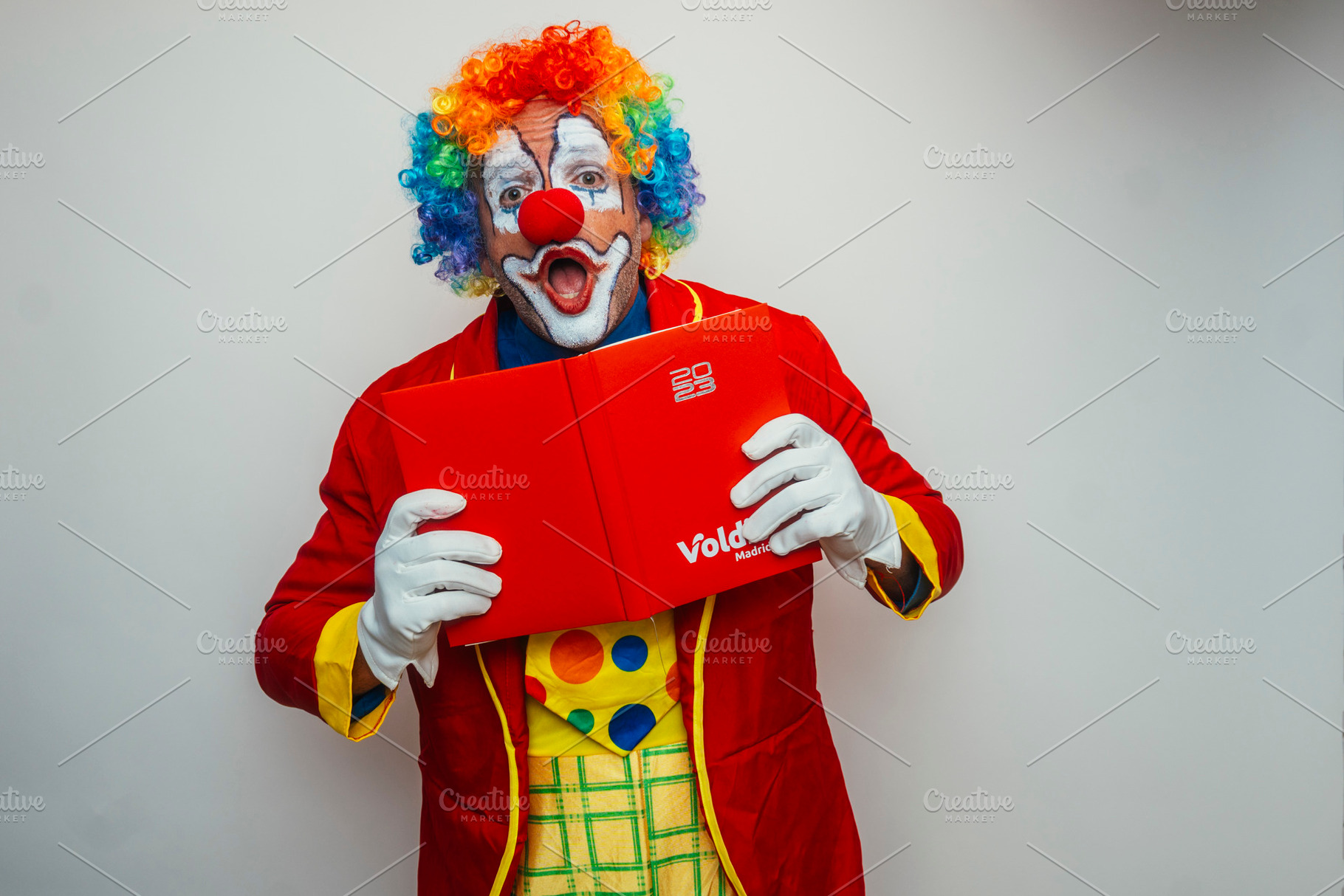 Clown looking at the camera with a funny pose, a Person Photo by karrastock