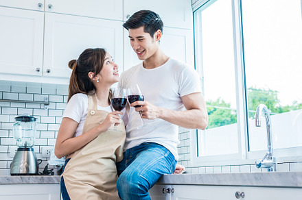 Asian lovers or couples drinking wine in kitchen room at home. L, a Person Photo by Ministocker