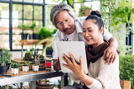 Senior couple asian family having good time using tablet compute
