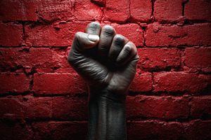 Strong fist raises against a red, a Photo by Pavel_design