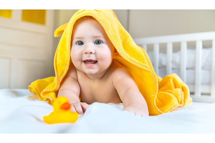 Baby after bathing in a towel, a Person Photo by yanadjana