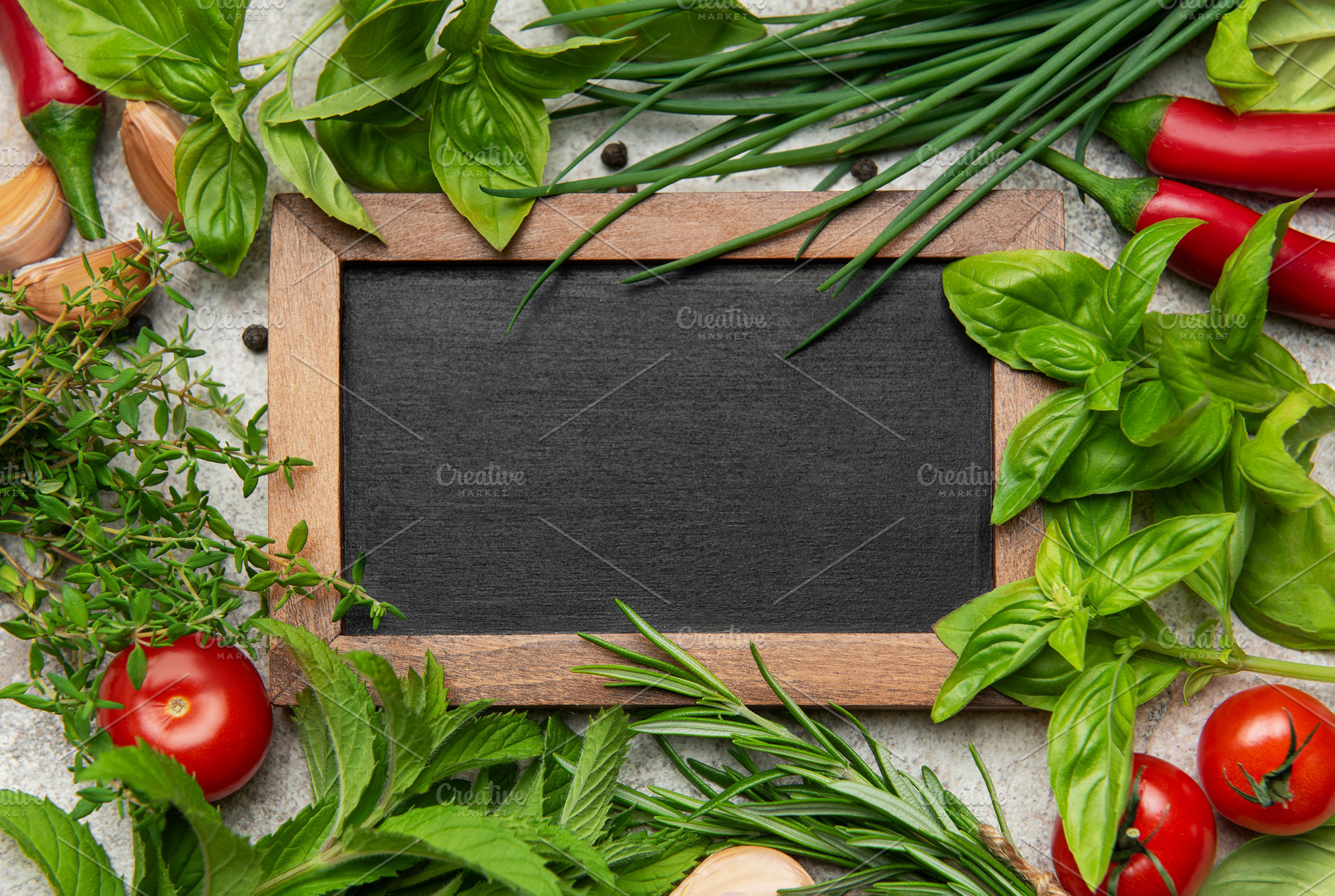 Fresh herbs and spices framing empty blackboard on gray backgrou, a Food & Drink Photo by Olena Rudo