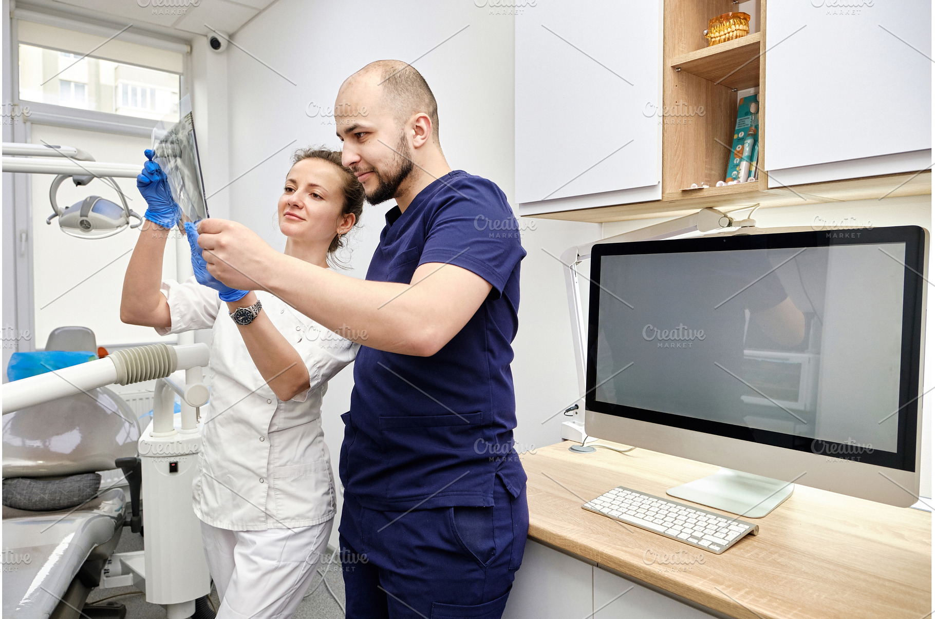 Male and Female Dentists Reviewing X, a Health & Medical Photo by Rohan Photography