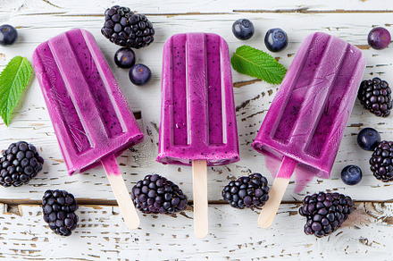 Ice cream popsicles with organic blackberries on wooden background, a Food & Drink Photo by AlyaAnd
