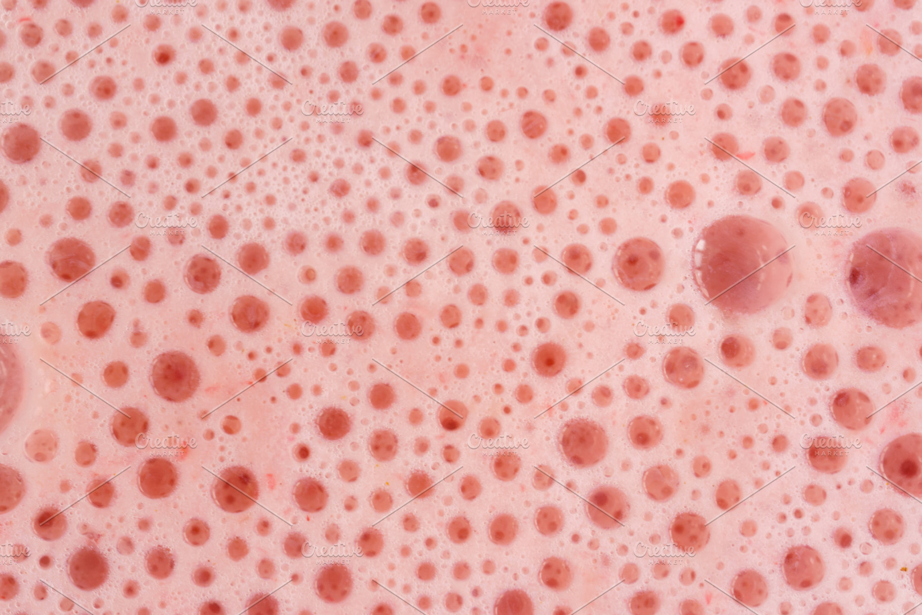 Pink foam texture with small bubbles on a light pink background. Close up macro, a Food & Drink Photo by Eugene_Photo