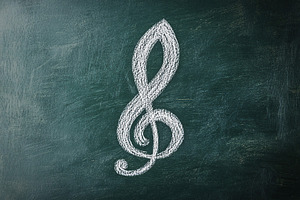 Music treble clef on green background, a Photo by AlyaAnd