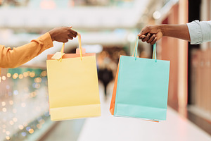 Closeup of black couple holding showing shopping bags, a Photo by Prostock-Studio