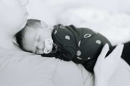 A newborn baby asleep on his mothers chest, a Person Photo by rubenchase