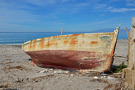 Old boat on the beach containing boat, beach, and nautical