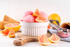 Tasty grapefruit ice cream, fruit citrus sorbet dessert, a Food & Drink Photo by Rimma