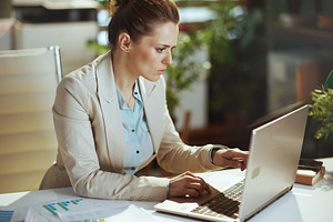 accountant woman in light business suit in green office, a Business Photo by Alliance Images