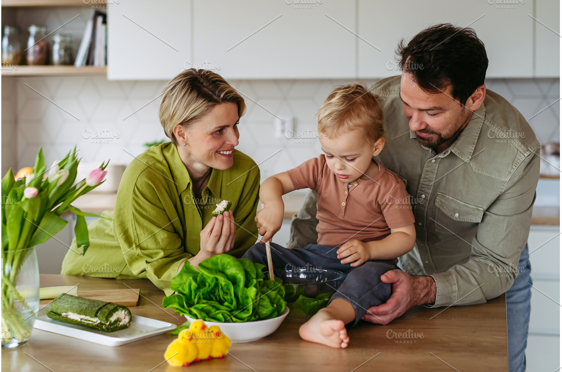 Family preparing lettuce salad to, a Food & Drink Photo by HalfPoint