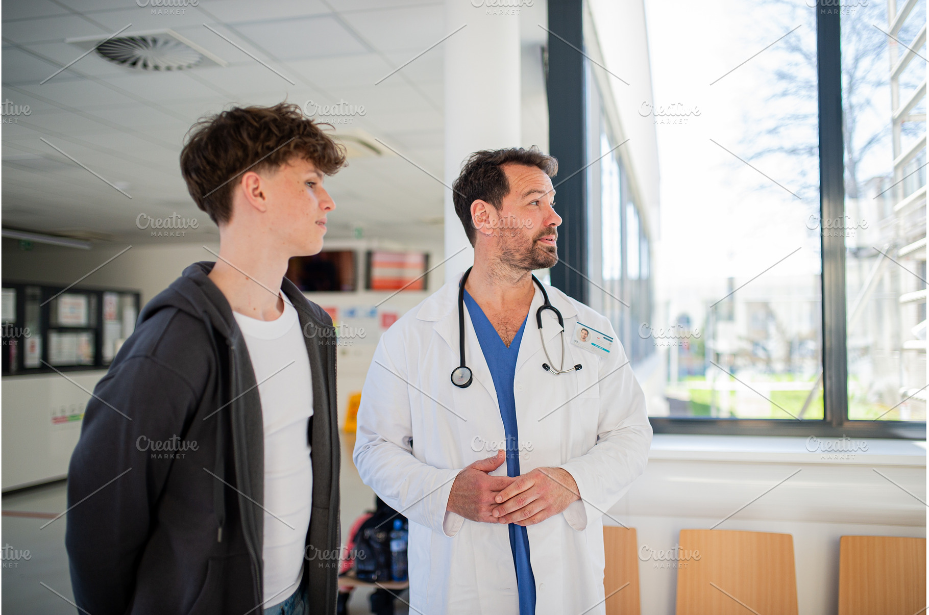 Doctor walking teenage patient out, a Person Photo by HalfPoint
