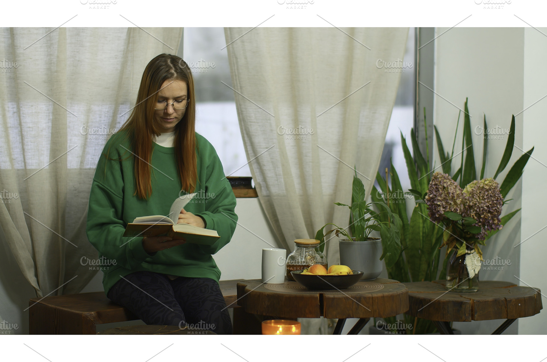 Young woman with glasses is reading, a Person Photo by Media Whale Stock