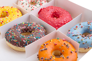 Set of donuts of various colors featuring donuts, sprinkles, and sugar